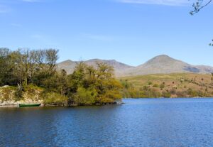 The calm surface of Coniston Water and the Old Man of Coniston.