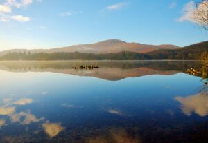 Glassy, still waters of Coniston Water in the Lake District.