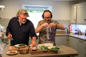 The Hairy Bikers cooking in the kitchen at Sawmill Cottage