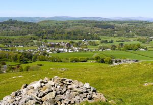 Wide view of Cartmel village and valley seen from the top of Hampsfell.