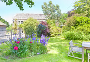 A sunny photo of the garden at Charcoal House