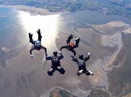 Image of sky divers over Morceambe Bay, Lake District
