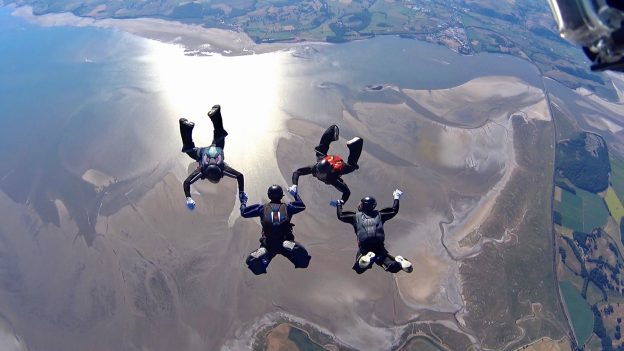 Image of sky divers over Morceambe Bay, Lake District